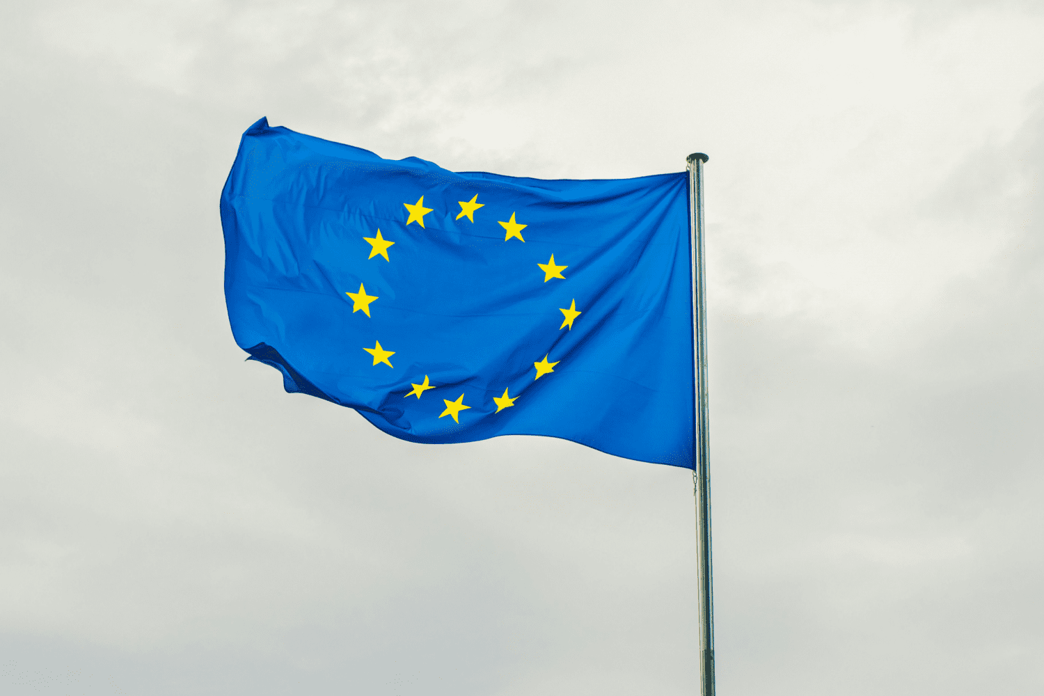 A flag flies in front of the European Commission building where the European Accessibility Act was signed into law in June 2019.